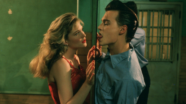 Amy Locane as Allison Vernon-Williams standing on one side of the jail glass in front of Johnny Depp as Wade "Cry-Baby" Walker as he licks the window in Cry-Baby