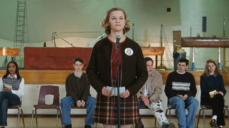 Reese Witherspoon as Tracy Flick giving her  student government president speech in front of other candidated, including Chris Klein as Paul Metzler, in Election