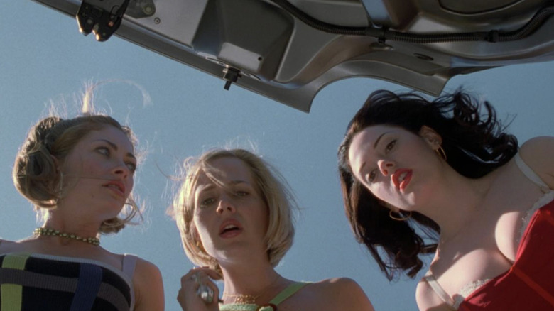 Rebecca Gayheart as Julie "Jules" Freeman, Julie Benz as Marcie "Foxy" Fox, and Rose McGowan as Courtney Shayne looking at their friend's dead body in the car trunk in Jawbreaker