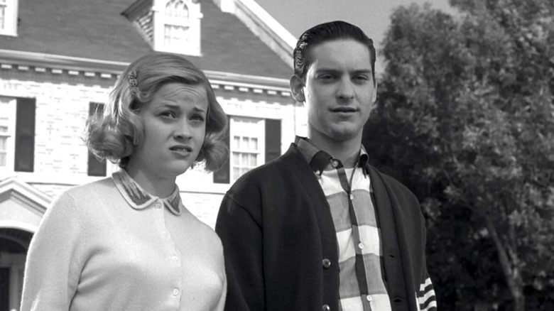 Tobey Maguire as David and Reese Witherspoon as Jennifer look at the neighborhood with concern in Pleasantville