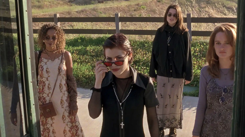 Rachel True as Rochelle Zimmerman, Fairuza Balk as Nancy Downs, Neve Campbell as Bonnie Harper, and Robin Tunney as Sarah Bailey in front of the bus saying "We are the weirdos mister" in The Craft