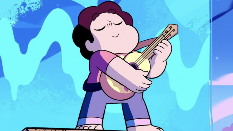 Steven Universe (voiced by Zach Callison) playing guitar on a stage with a blue background in Steven Universe