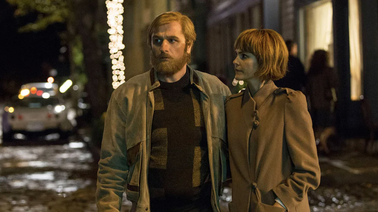 Matthew Rhys as Philip Jennings AKA Mischa staning with Keri Russell as Elizabeth Jennings AKA Nadezhda on the street wearing disguises and jackets in The Americans