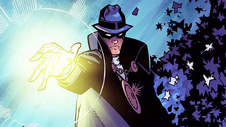 The Phantom Stranger fires a light amid leaves in DC Comics