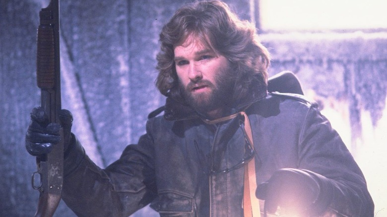 Macready investigates with a shotgun