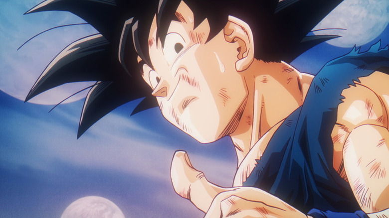 A beat-up Goku smiles and gives a thumbs up in Dragon Ball Daima
