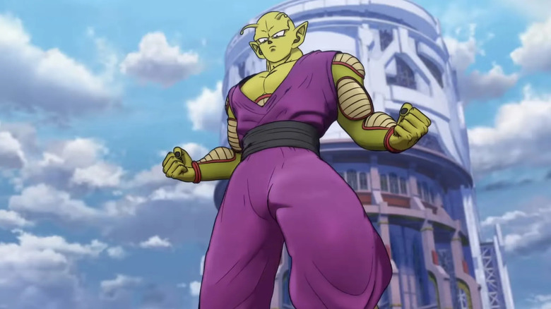 Piccolo stands posing in front of a large tower in Dragon Ball Super: Super Hero