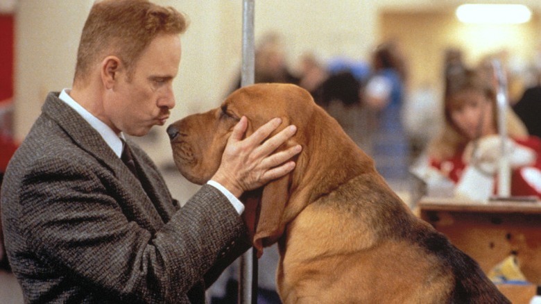 Christopher Guest smooches a basset hound.
