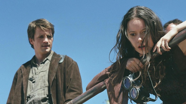 Nathan Fillion as Mal staring at Summer Glau as Riiver leaning over a railing in Serenity (2005)