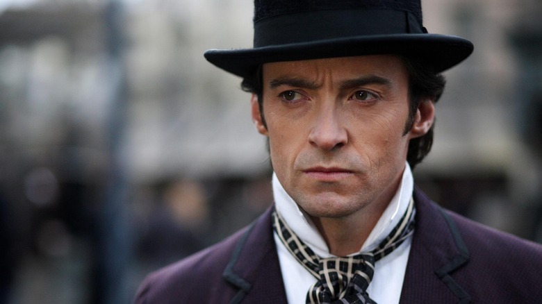 Hugh Jackman as Lord Caldlow in a top hat walking down the street in The Prestige