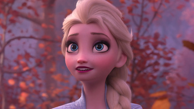 Elsa looking up in a forest in Frozen
