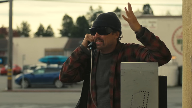 Pat yelling on a pay phone in One Battle After Another