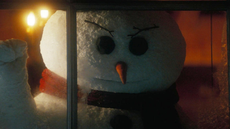 An angry snowman knocking on a window in The Naked Gun (2025)
