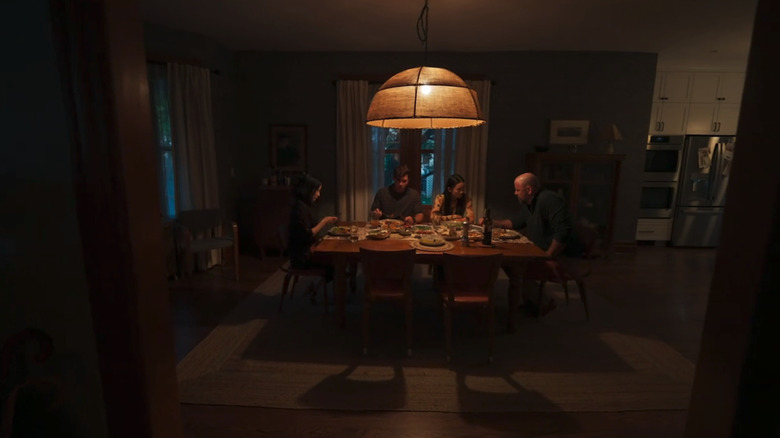 A family gathers around a dinner table in Presence