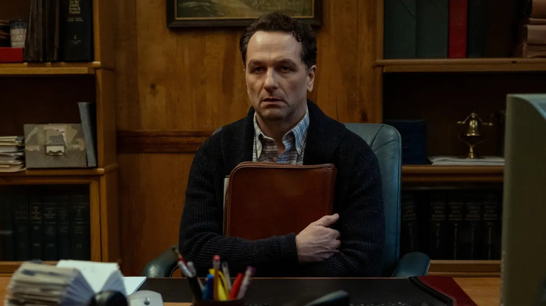 Tom hugging files at his desk on Widow's Bay