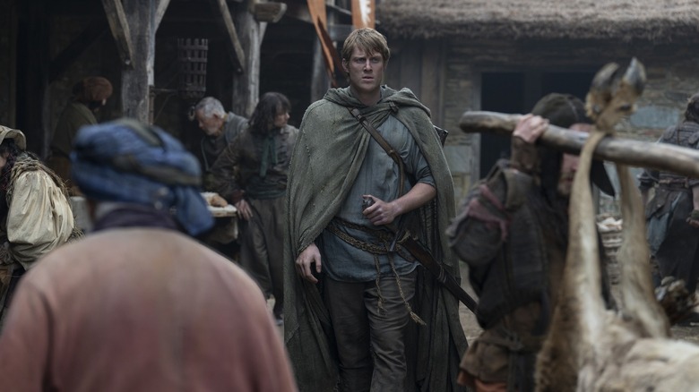 Peter Claffey as Dunk walking through a town in A Knight of the Seven Kingdoms