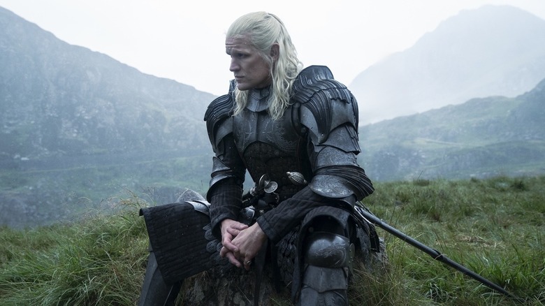 Matt Smith as Daemon Targaryen sitting on a hill in House of the Dragon