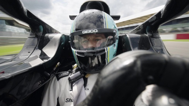 Brad Pitt as Sonny in the cockpit of his car on the racetrack in F1: The Movie