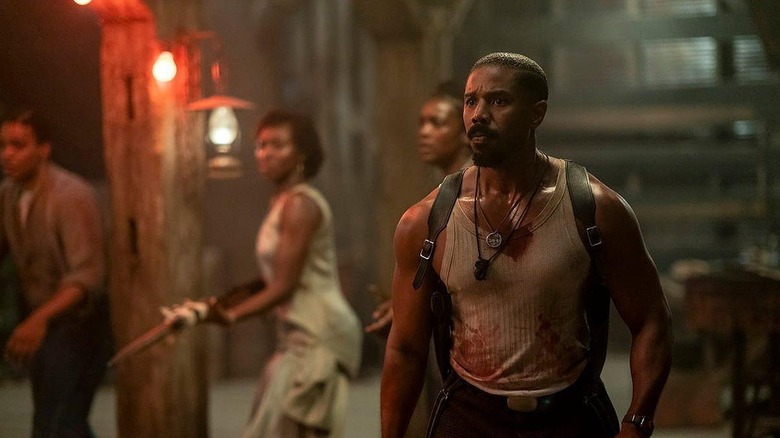 Michael B. Jordan as Smoke getting ready to defend the bar from the vampires in Sinners