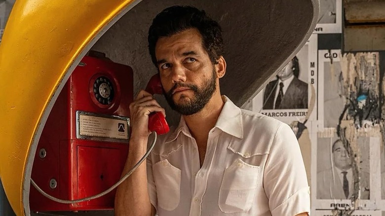 Wagner Moura as Armando Solimões, answering a phone in The Secret Agent