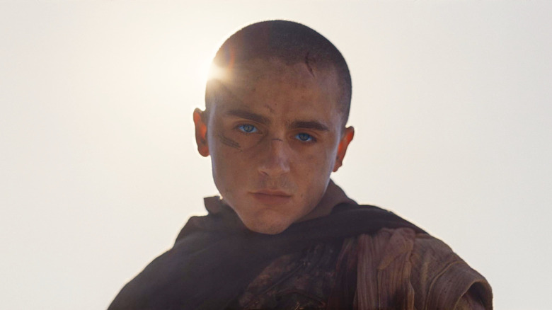 Timothée Chalamet as Paul Atreides looking downwards with the sun behind his head in Dune: Part Three