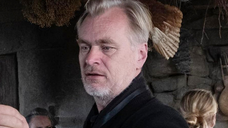 Christopher Nolan standing inside the set for Circe's hut in The Odyssey (2026)