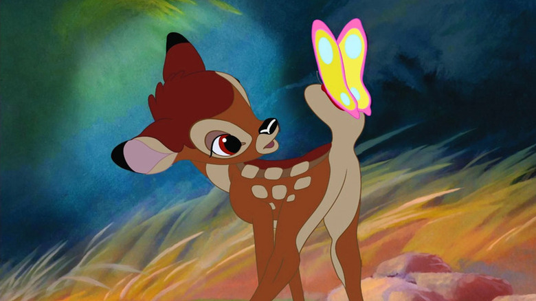 Bambi examines a butterfly resting on his tail in Bambi