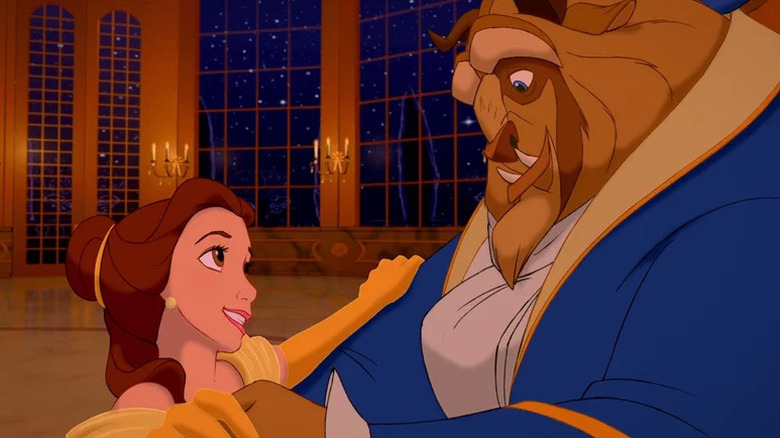 Belle (Paige O'Hara) smiles up at Beast (Robby Benson) as they dance in Beauty and the Beast