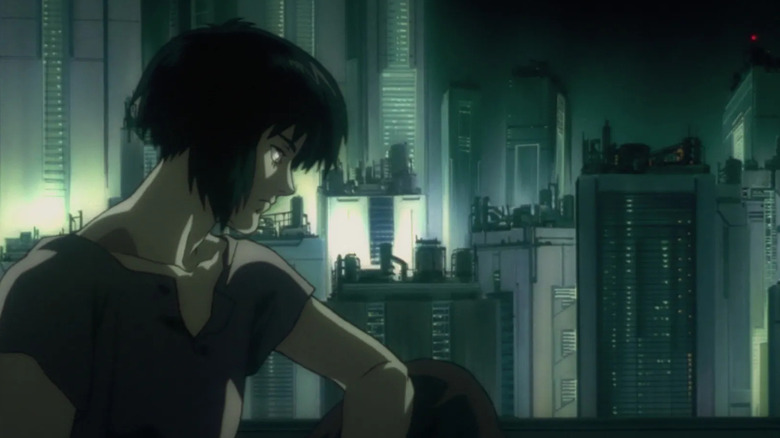 Motoko Kusanagi (Atsuko Tanaka) sits overlooking the city in Ghost in the Shell (1995)