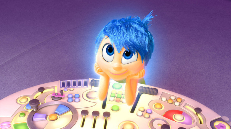 Joy (Amy Poehler) rests her elbows on a console while gazing up in Inside Out