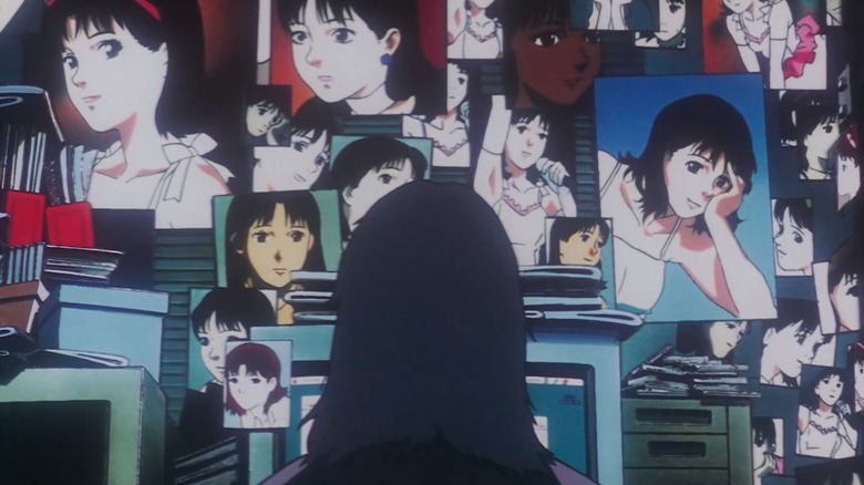A mysterious figure sits at ac omputer in front of many images of Mima Kirigoe (Junko Iwao) in Perfect Blue