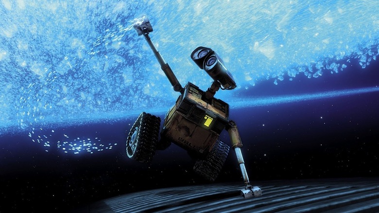 WALL-E (Ben Burtt) touches stardust while holding onto a spaceship in WALL-E