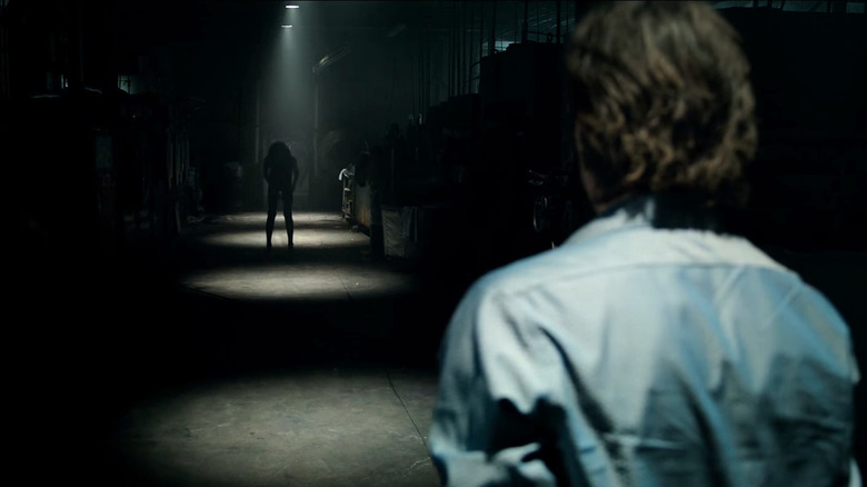 Billy Burke's Paul looking at the demon in the darkness in Lights Out