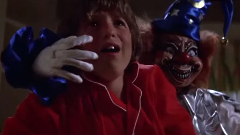 A clown doll attacking Oliver Robin's Robbie Freeling