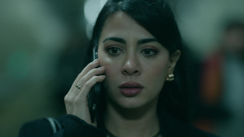 Emeraude Toubia's Rosario Fuentes talking on the phone in Rosario