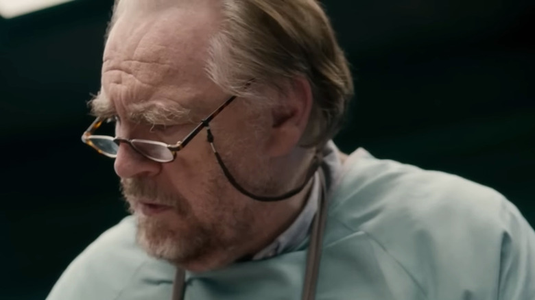 Brian Cox's Tommy Tilden looking down in The Autopsy of Jane Doe