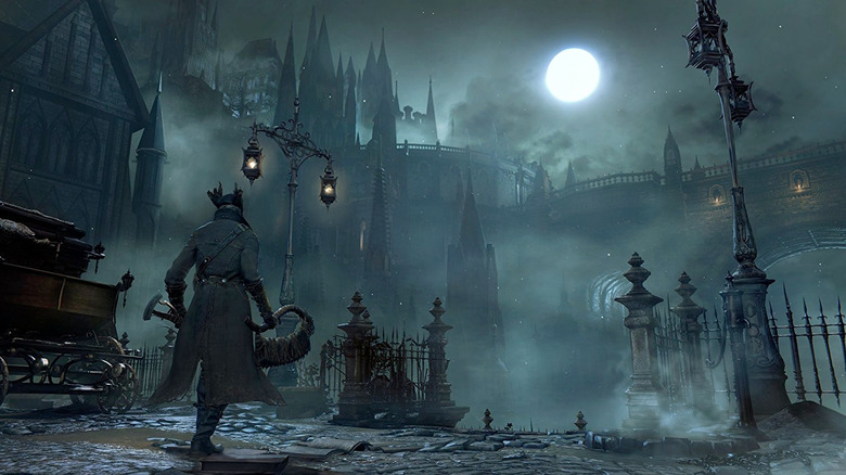 A player walking through a dark town in Bloodborne
