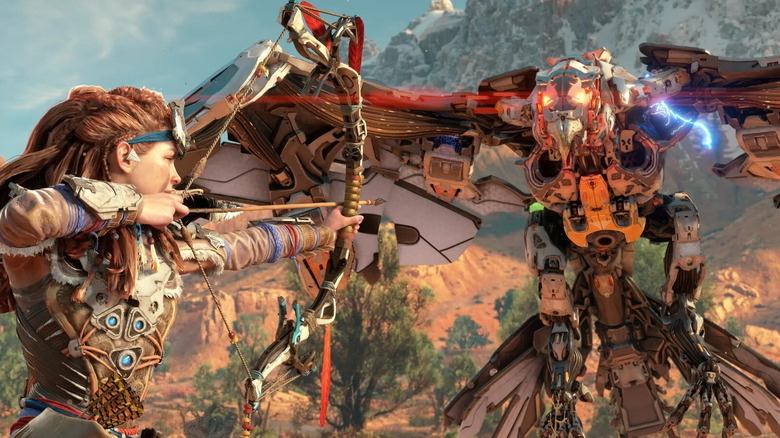 Aloy aiming a bow and arrow at a mechanical bird in Horizon Zero Dawn