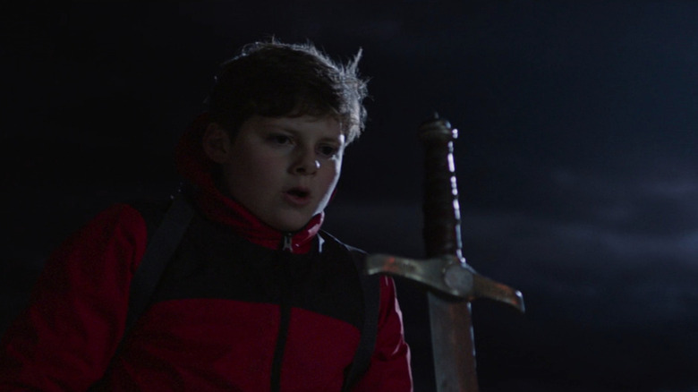 Alex (Louis Ashbourne Serkis) looking at the sword in the stone in The Kid Who Would Be King