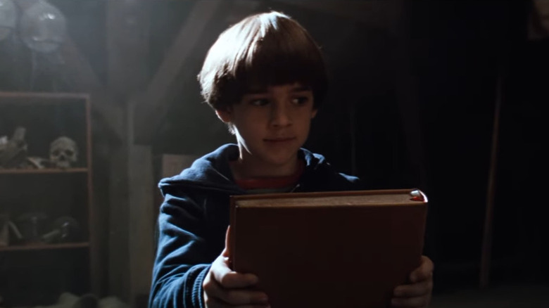 Bastian (Barret Oliver) holds book in The Neverending Story