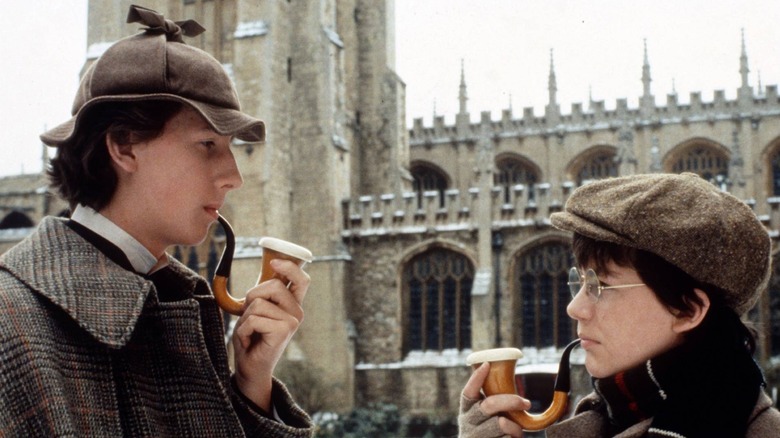 Sherlock Holmes (Nicholas Rowe) and John Watson (Alan Cox) smoking pipes in Young Sherlock Holmes