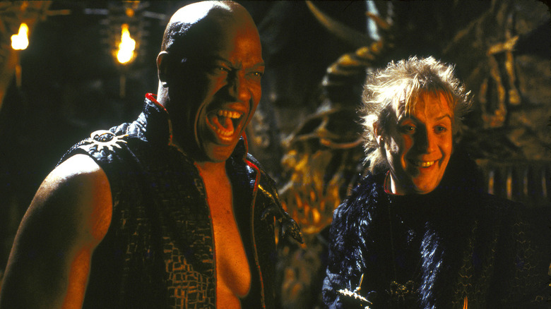 Tom Lister Jr. as Cassius and Rhys Ifans as Adrian laughing side by side in Little Nicky