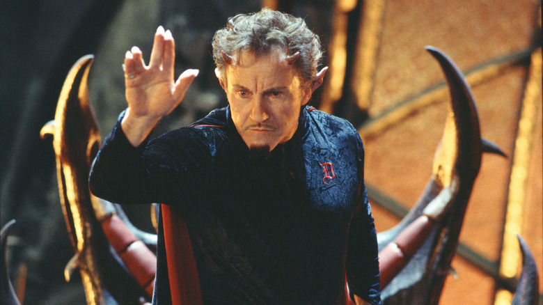 Harvey Keitel as Satan standing in front of his chair in Little Nicky