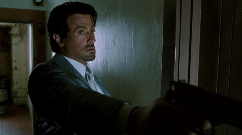 Sylvester Stallone as Jack Carter holding his gun out in front of him in Get Carter (2000)