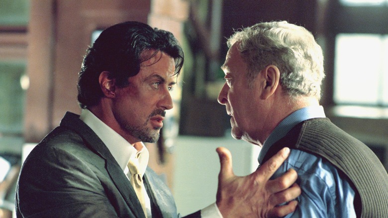 Sylvester Stallone as Jack Carter talking face to face with Michael Caine as Cliff Brumby in Get Carter (2000)