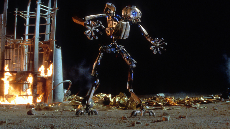 The robot standing amidst flaming wreckage in Red Planet