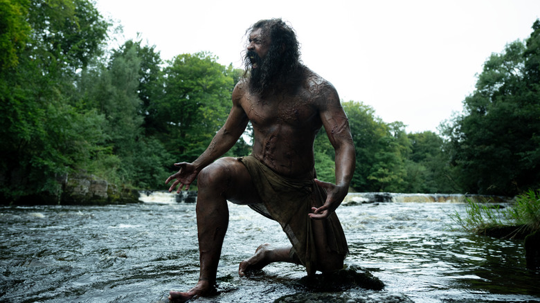 Samson kneeling down in a creek in 28 Years Later: The Bone Temple