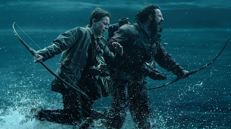 Spike and Jamie running through water at night