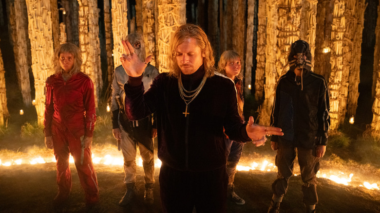 Jack O'Connell as Sir Jimmy Crystal leading his cult members (known as the Jimmies) in a ring of fire in 28 Years Later: The Bone Temple