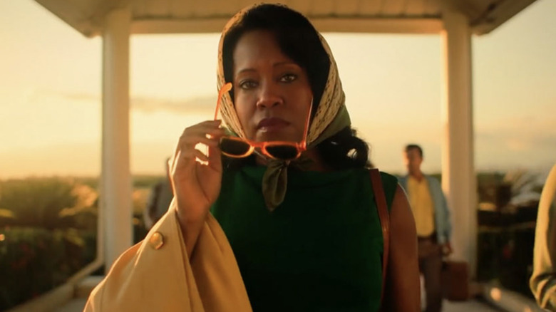 Regina King as Sharon Rivers holding sunglasses and wearing a head scarf in If Beale Street Could Talk